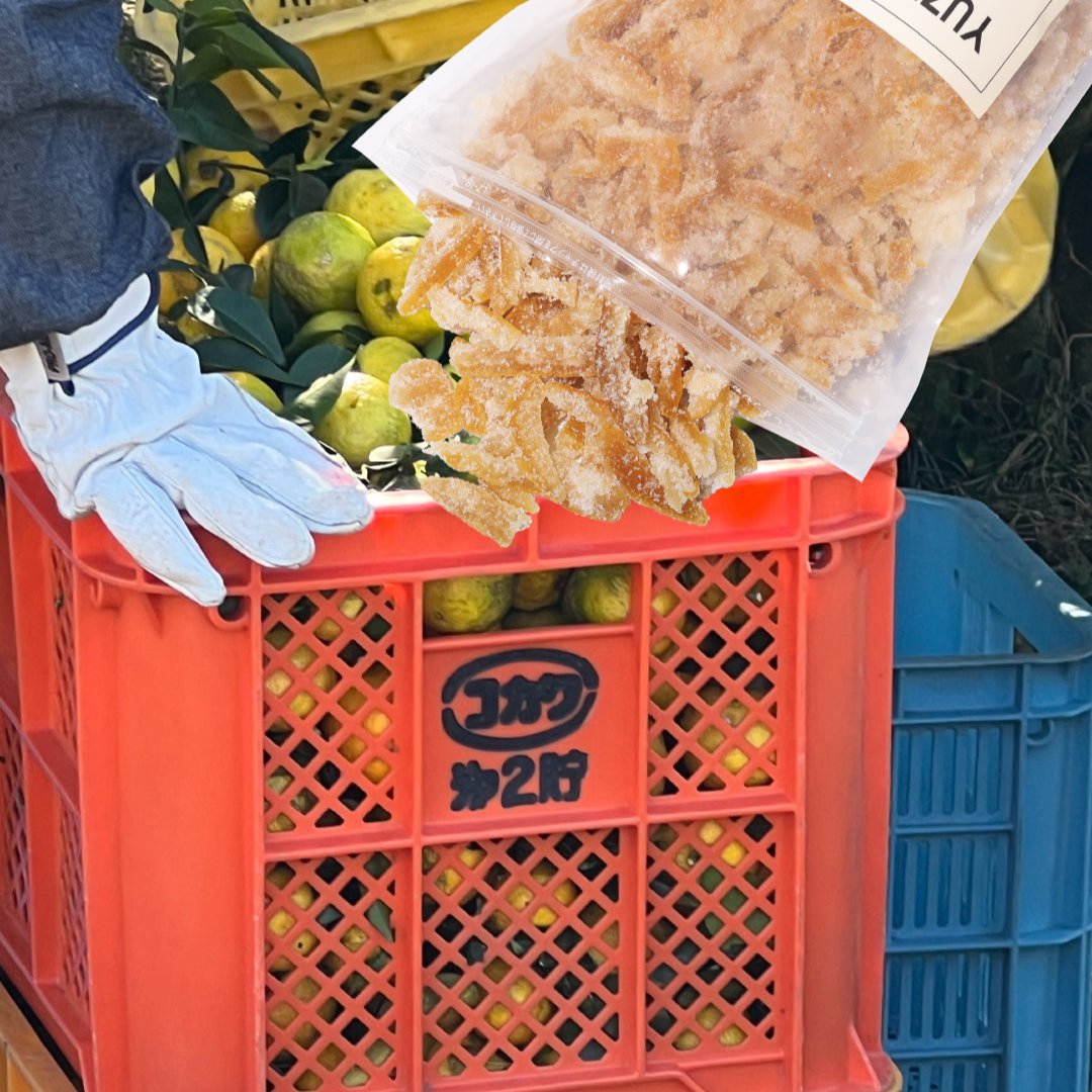 Candied yuzu peel spilling out over image of fresh yuzu